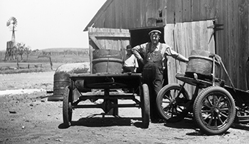 Image of a man  with machinery near a barn