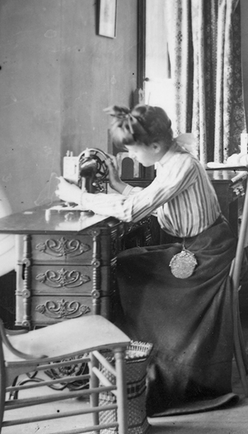 Image of a woman sitting with a sewing machine